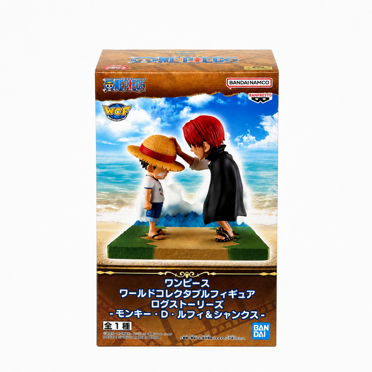 ONE PIECE World Collectable Figure Log Stories Monkey D. Luffy & Shanks WCF box front with bright seaside backdrop showing Shanks placing straw hat on young Luffy on grass dock diorama base, Bandai Namco Banpresto collectible
