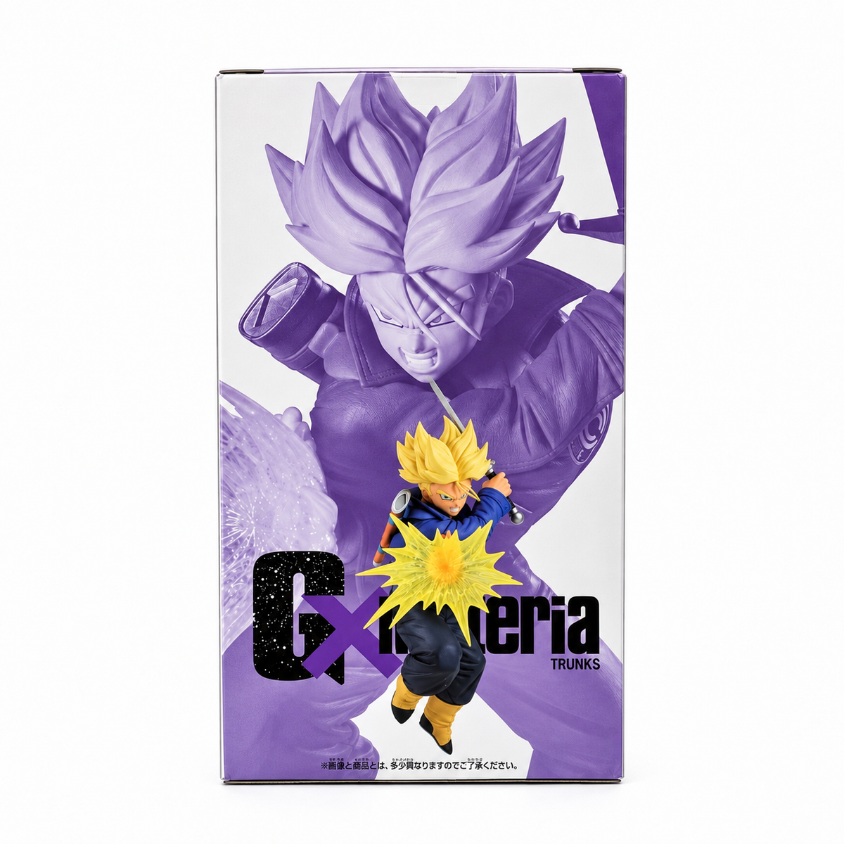 Dragon Ball Z G×materia Trunks figure box side showing purple monochrome sculpture render of Trunks raising sword overhead with small full-color figure and yellow energy burst in foreground, galaxy texture G×materia logo, Banpresto Bandai Spirits collectible
